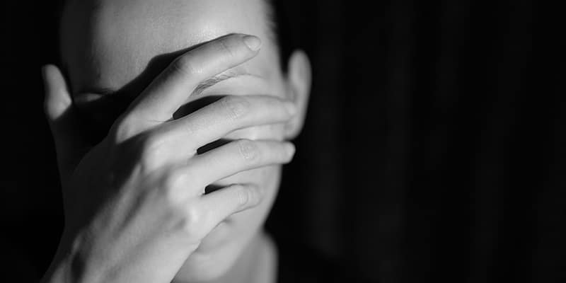addiction-dependence Man with hands over his face