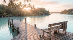 Peaceful wooden dock overlooking calm water in Port St. Lucie, Florida, with morning light and palm trees suggesting a place for healing and reflection
